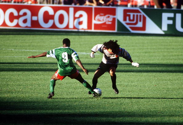 1990 World Cup Finals. Second Phase. Naples, Italy. 23rd June, 1990. Cameroon 2 v Colombia 1. Cameroon's Roger Milla tackles eccentric Colombian goalkeeper Rene Higuita in midfield. Milla won the ball and ran it in to an empty net to score the winning goa